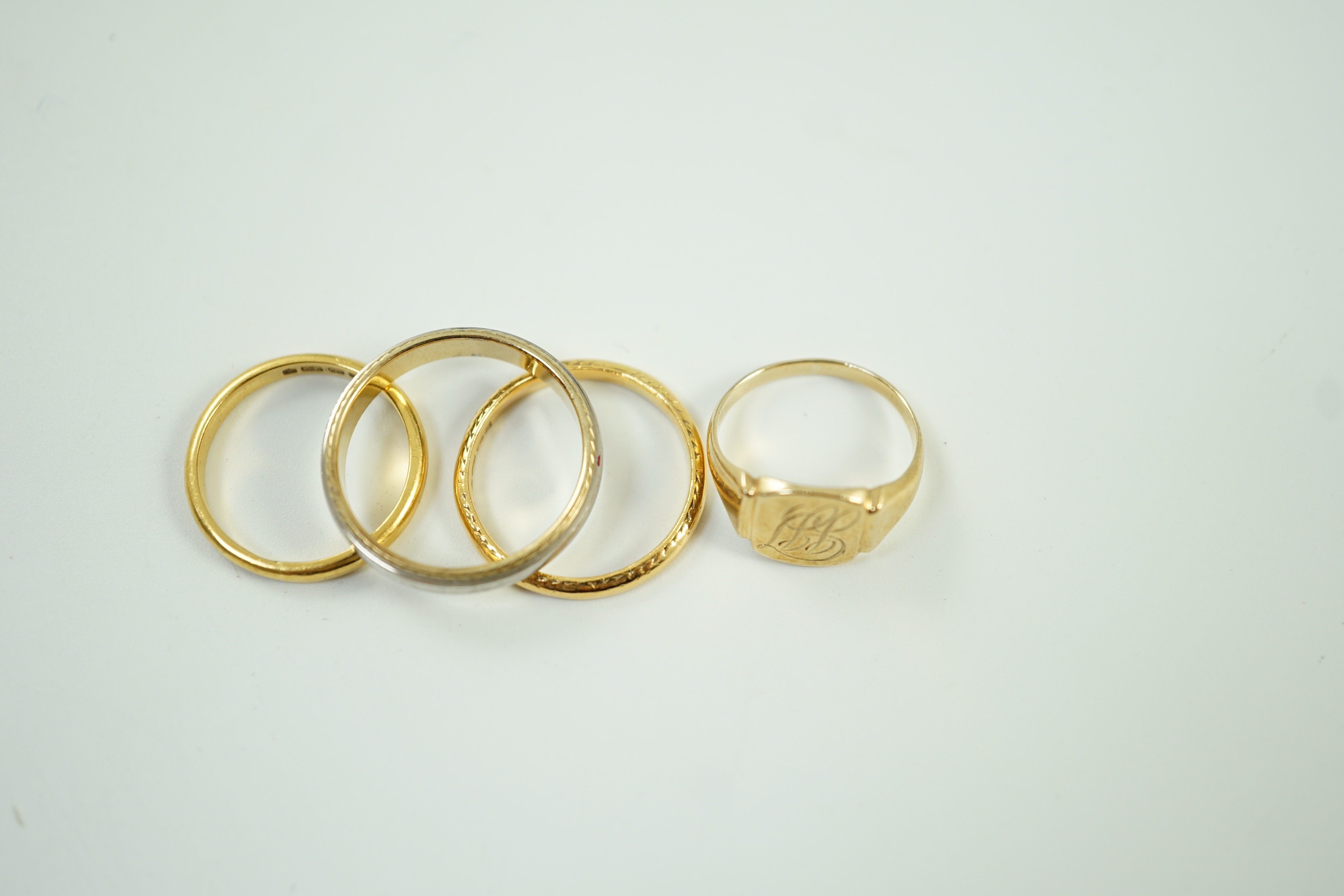 Two 22ct gold wedding bands, 5.2 grams, a 9ct gold signet ring, 2.4 grams and a two colour 750 yellow metal band, 4.4 grams.